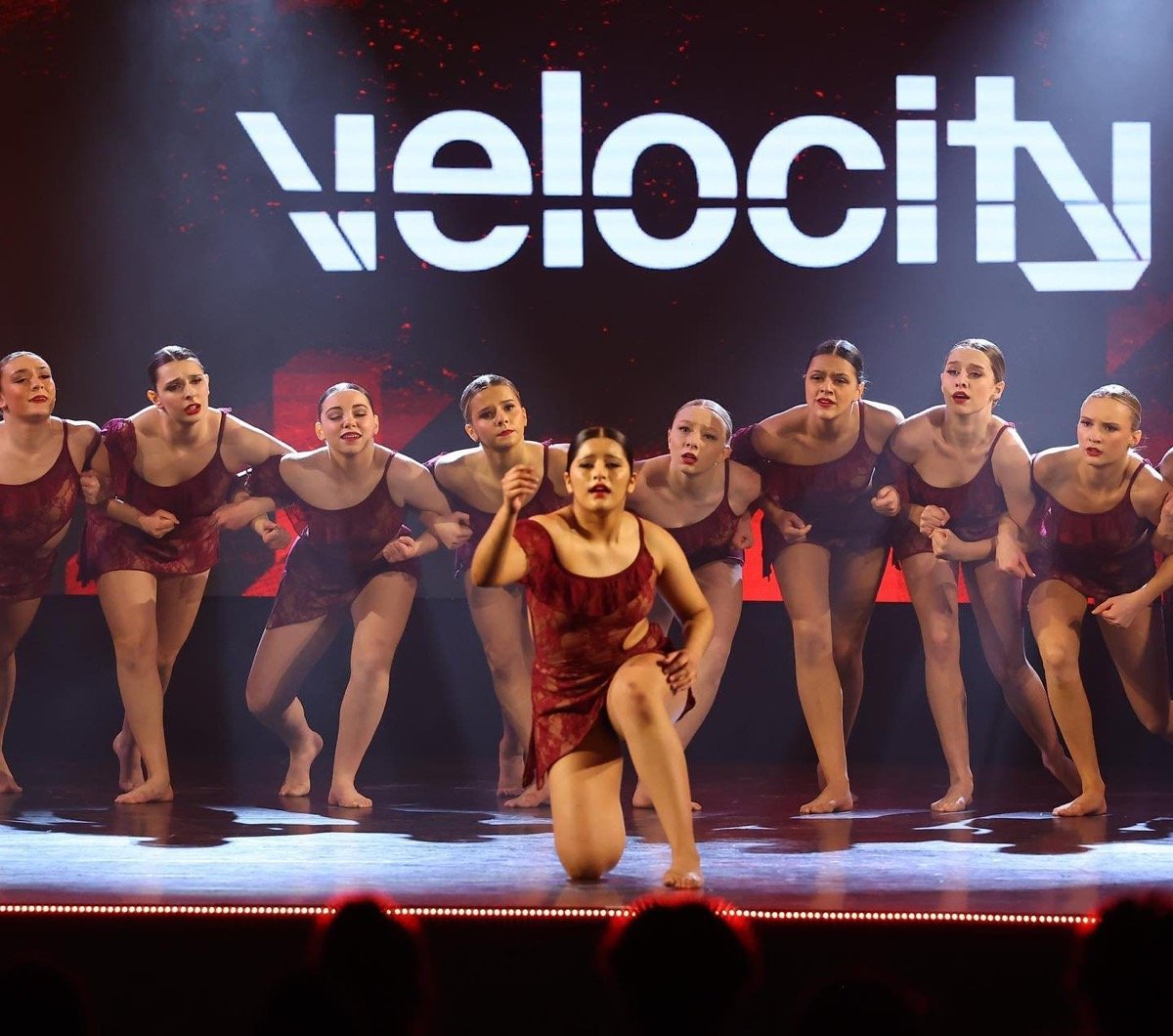 Competitive dance studio team on stage in custom Show Off costumes